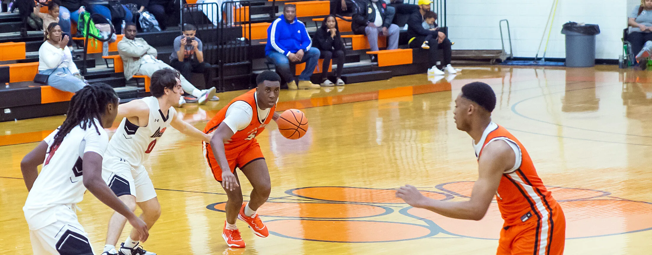Hargrave basketball players on the orange Tiger court